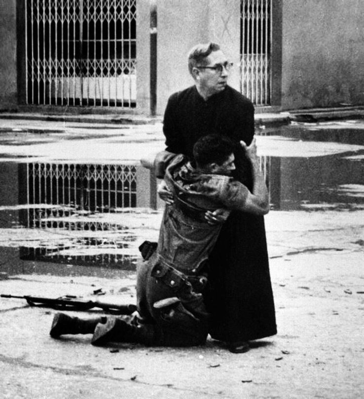 15. Soldier hugs a priest